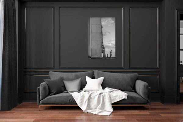 Moderne woonkamer met grijze bank en zwart-wit kunstwerk.